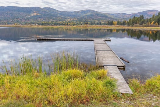 Looking out at the dockon the calm McArthur Lake in north Idaho.