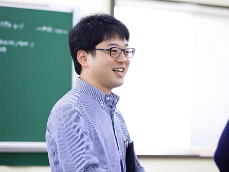 Male Asian Teacher teaching children in the Classroom School