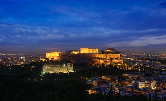 Famous greek tourist landmark - the iconic Parthenon Temple at the Acropolis of Athens as seen from Philopappos Hill in the evening blue hour, Athens, Greece