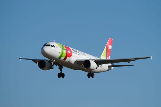 Lisbon, Portugal - September 2, 2023: TAP Portugal Airbus A320-214 passenger plane descend to land in Humberto Delgado Airport in Lisbon