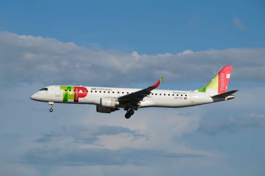 Lisbon, Portugal - September 2, 2023: TAP Express Embraer E195AR passenger plane landing in Humberto Delgado Airport in Lisbon