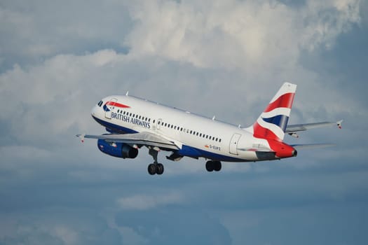 Lisbon, Portugal - September 2, 2023: British Airways Airbus A319-131 passenger plane in sky with clouds after take off in Humberto Delgado Airport in Lisbon