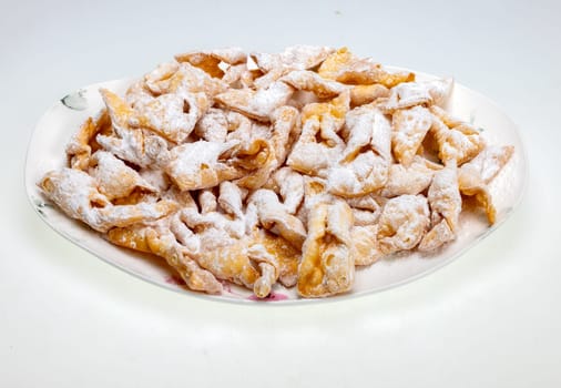 Angel wings (Faworki), cakes. Sweet pastry deep fried and sprinkled with powdered sugar