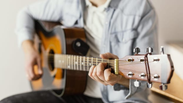 close up musician playing guitar. High resolution photo