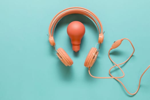 earphones lamp colored surface. High resolution photo