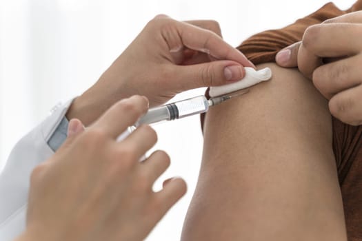 doctor vaccinating man close up. High resolution photo