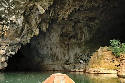 On the boat entering Kong Lor Cave, a tourist attraction on the Thakhek Motorbike Loop, Laos 2023