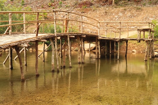 Bamboo bridge, jetty at the Kong Lor Cave, a tourist attraction on the Thakhek Motorbike Loop, Laos 2023
