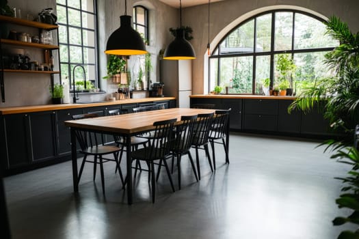 Spacious industrial style kitchen with large windows, wooden countertops, and modern lighting fixtures.