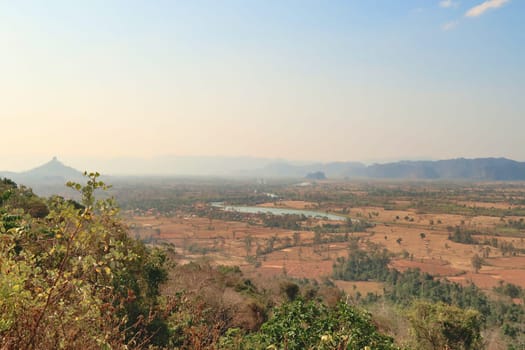 Spectacular view onto Ban Namsanam village, town and the landscape that surrounds it, close to Ba Hin, another small village, town on the Thakhek Motorbike Loop, Laos 2023