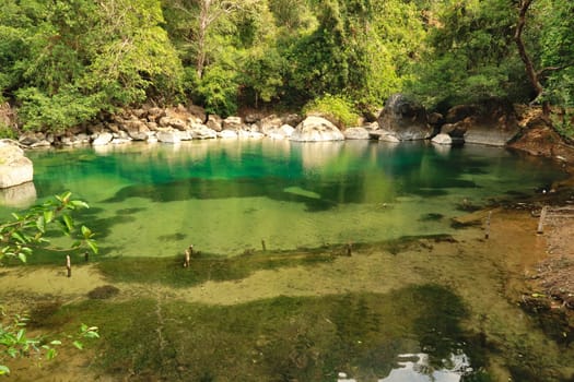 At the cool pool, a small pond, lake, lagoon with intense green water on the Thakhek Motorbike Loop, Laos 2023