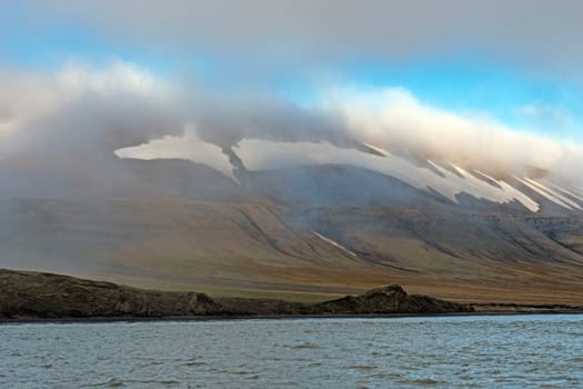 Mountains Looming Through the Coastal Fog at Kapp Waldburg in the Svalbard Islands