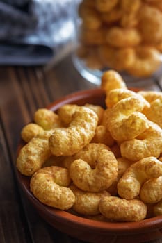 Puffed crispy Peanut flips in bowl on a wooden table.
