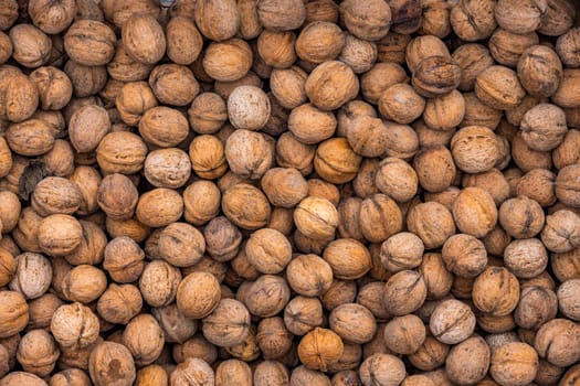 pile of unpeeled walnuts with high angle view, full-frame texture and background