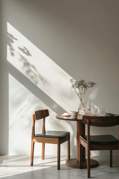 A wooden table with two chairs and a vase of flowers on it. The table is set for a meal, with cups and a bowl placed on it