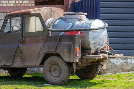 old soviet 4x4 converted to a pickup with barrel for small farmers milk collection and reselling it to a dairy plant in rural Kyrgyzstan