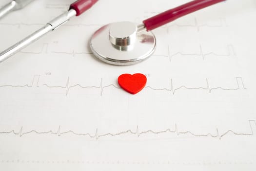 Stethoscope on electrocardiogram (ECG), heart wave, heart attack, cardiogram report.