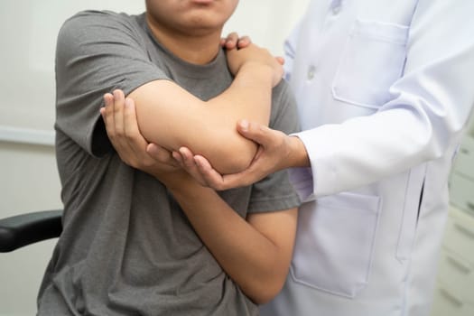 Physical therapy, Asian therapist doctor treat perform pain young man in hospital.