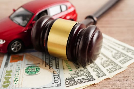 Car accident lawsuit and insurance, Judge hammer and money with car model.