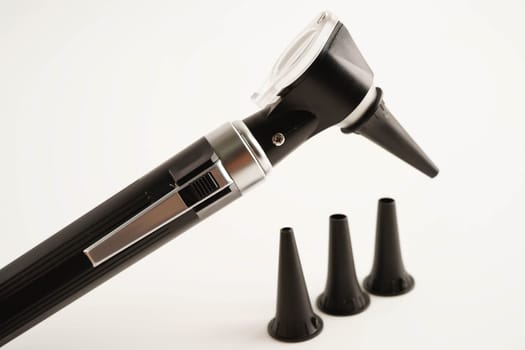 Otoscope isolated on white background for otolaryngologist or ENT physician doctor examining senior patient ear, hearing loss problem.