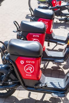 RIGA, LATVIA - JUNE 16, 2024: Electric bikes and scooters for rent in the Latvian capital