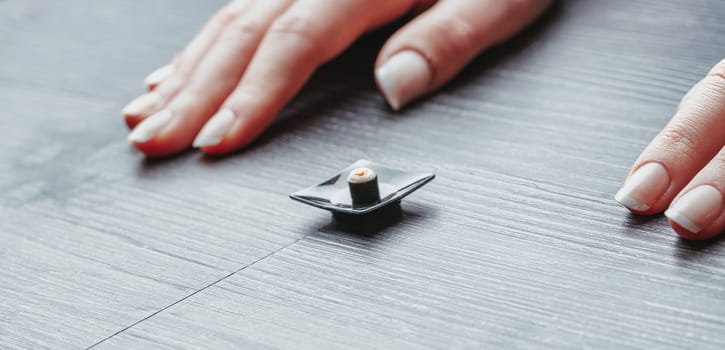 Small sushi portion on a tiny plate illustrates correct dietary habits. While visually minimal, it captures the discipline needed to adapt to correct nutritional portions