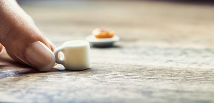 Breakfast constraints, including diet, lactose and gluten intolerance, time, and cost, make morning meals unsatisfying, as symbolized by the tiny coffee and pastry. Fulfillment seems unattainable