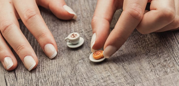 minuscule coffee and pastry express frustration in balancing diet restrictions, intolerances, and financial limits. Lack of time worsens the feeling of an incomplete breakfast
