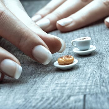 microscopic coffee and pastry reflect dietary limitations due to sugar, lactose, and gluten intolerances, along with cost and time constraints, capturing the feeling of an unfulfilled breakfast