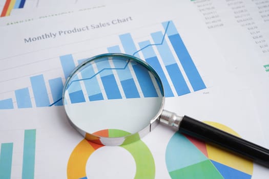 Magnifying glass on charts graphs paper. Financial development, Banking Account, Statistics, Investment Analytic research data economy.