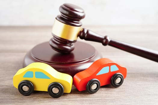 Bangkok, Thailand March 15, 2024 Car accident lawsuit and insurance, Judge hammer and money with car model.