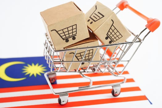 Online shopping, Shopping cart box on Malaysia flag, import export, finance commerce.
