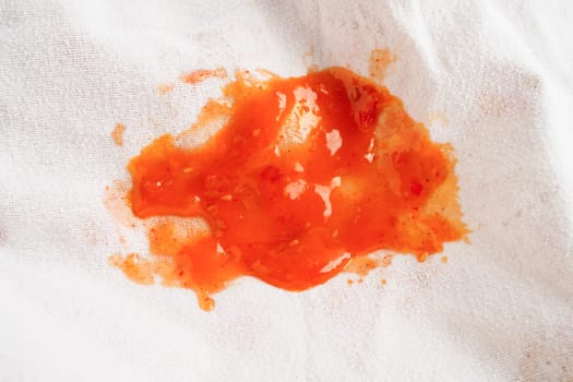 Dirty tomato sauce stain or ketchup on cloth to wash with washing powder, cleaning housework concept.