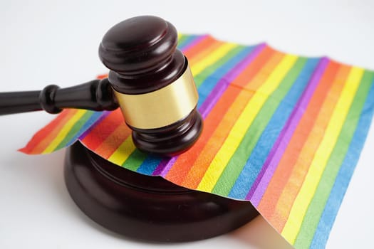 Gavel for judge lawyer on rainbow flag, symbol of LGBT pride month.