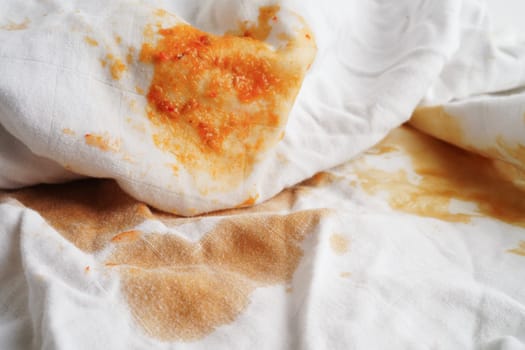 Dirty tomato sauce stain or ketchup on cloth to wash with washing powder, cleaning housework concept.