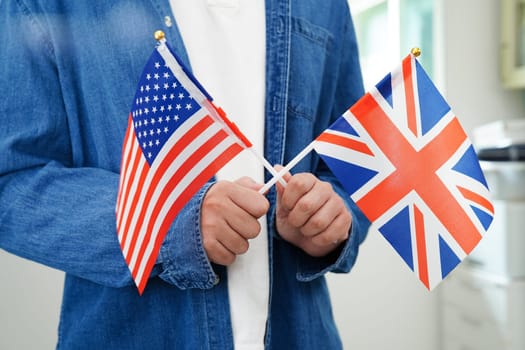 Learning English, Asian teenage student holding flag for language program education.