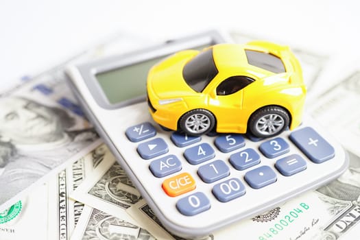 Bangkok, Thailand November 18, 2023 Car on banknote money with calculator, buying or insurance concept.