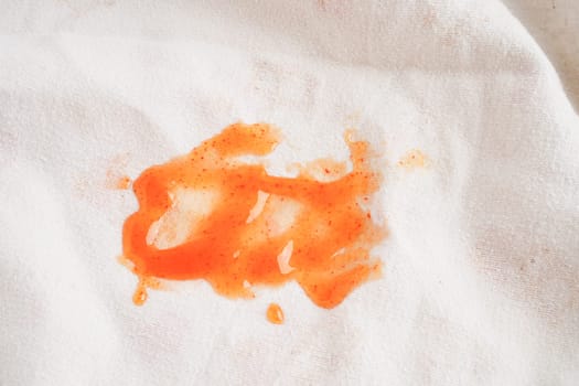 Dirty tomato sauce stain or ketchup on cloth to wash with washing powder, cleaning housework concept.