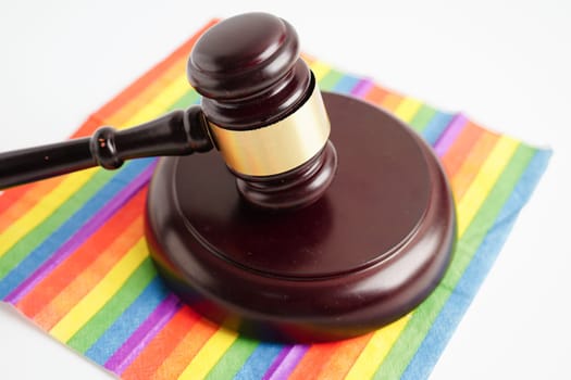 Gavel for judge lawyer on rainbow flag, symbol of LGBT pride month.