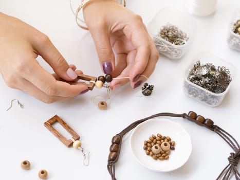 woman making accessories with wooden beads. Resolution and high quality beautiful photo