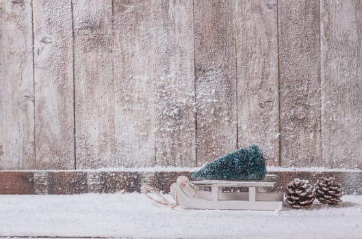 wooden wall with small sleigh with christmas tree. Resolution and high quality beautiful photo
