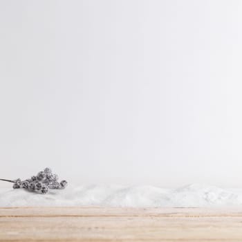 wood board near plant twig on heap of snow. Resolution and high quality beautiful photo
