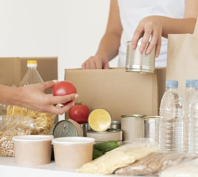 volunteers putting canned food water donation bag. Resolution and high quality beautiful photo