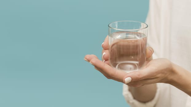 woman holding glass filled with water copy space. Resolution and high quality beautiful photo