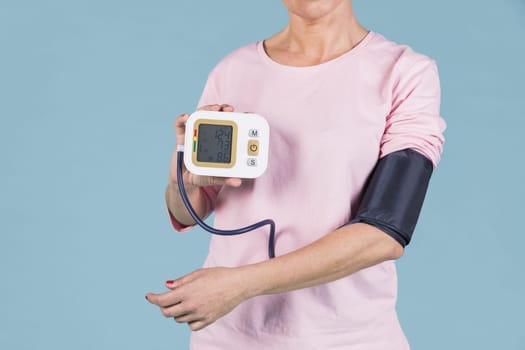 woman showing results blood pressure electric tonometer screen. Resolution and high quality beautiful photo