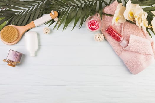 towel salt bottle brush flowers leaves wooden background. Resolution and high quality beautiful photo
