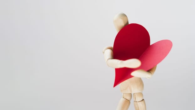 toy manequin holding heart with copy space. Resolution and high quality beautiful photo