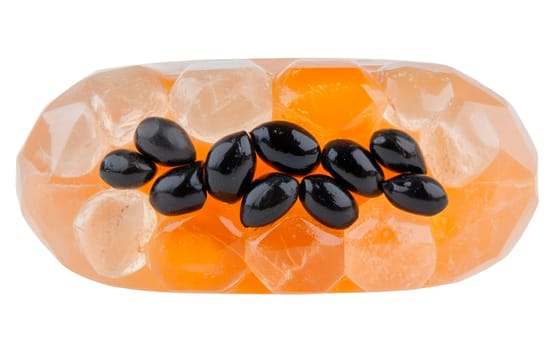 A piece of artistic papaya jelly embedded with white seeds, highlighted on a white background, capturing its unique texture. Isolated on white background.