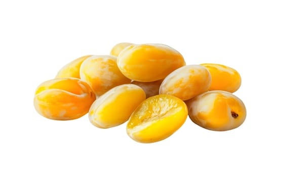 A heap of yellow mirabelle plums on a white background, highlighting their sweet and juicy characteristics with copy space. Isolated on white background.