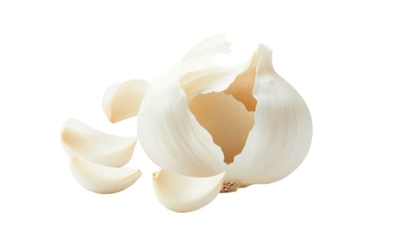 A whole garlic bulb with partially separated cloves, artistically arranged on a white background, highlighting its natural texture. Isolated on white background.